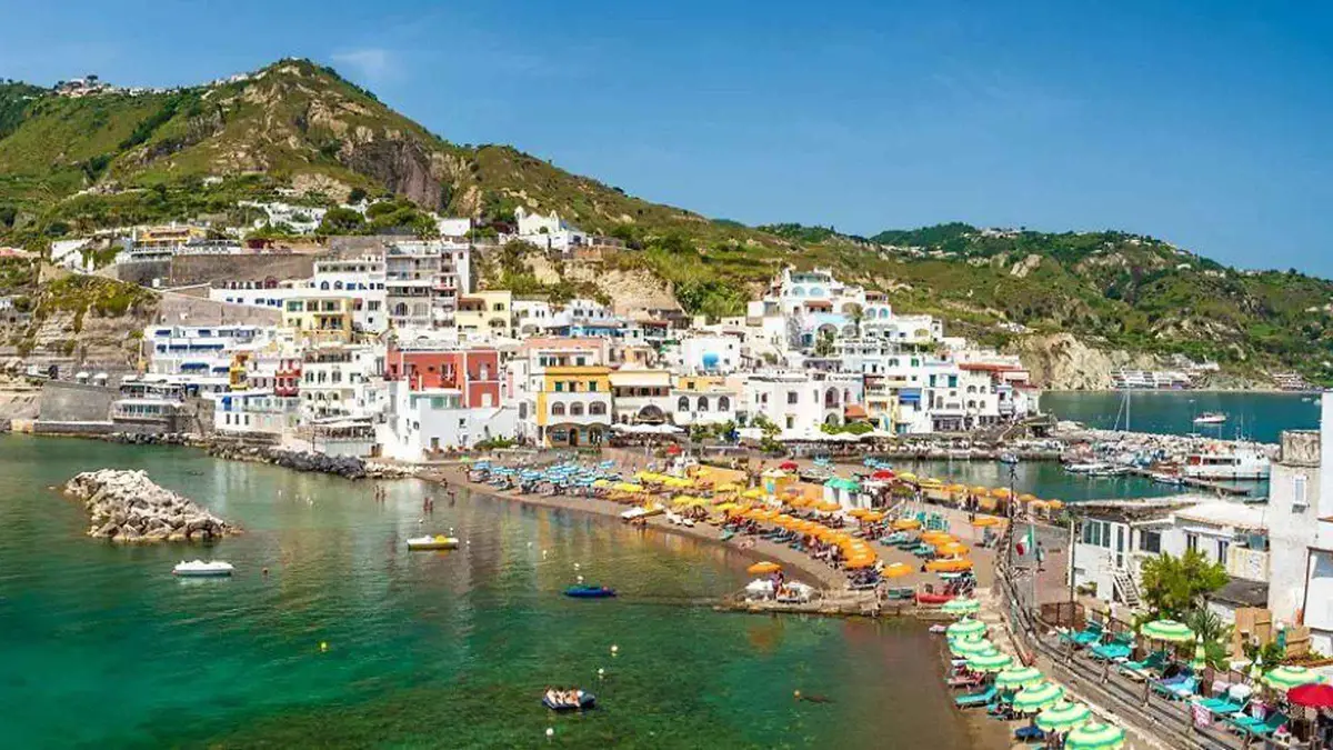 Motorboat Ulisse cruising the Ischia coast with passengers on an island tour with a free stop in Sant'Angelo, Campania, Italy